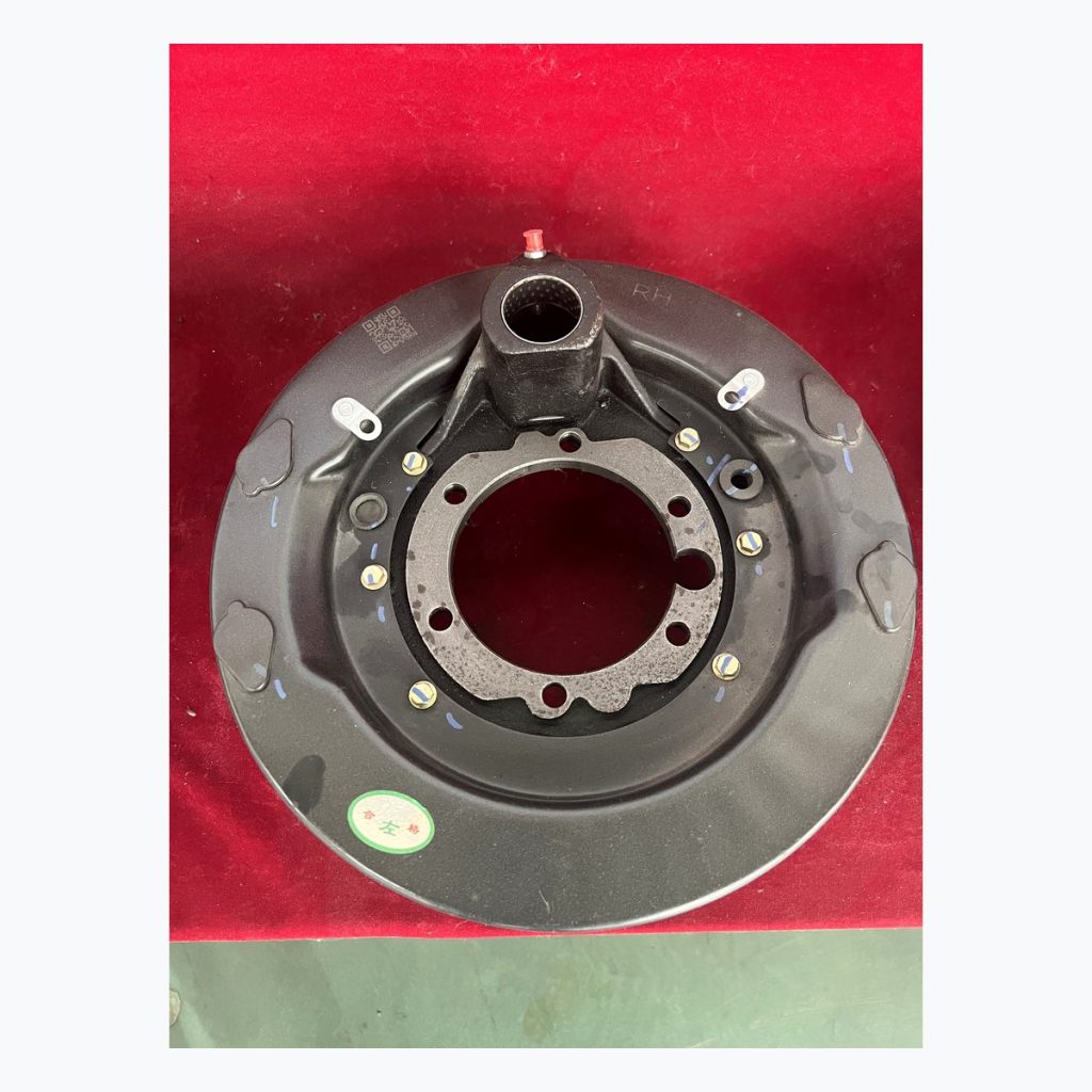 Complete brake backing plate assembly on red table