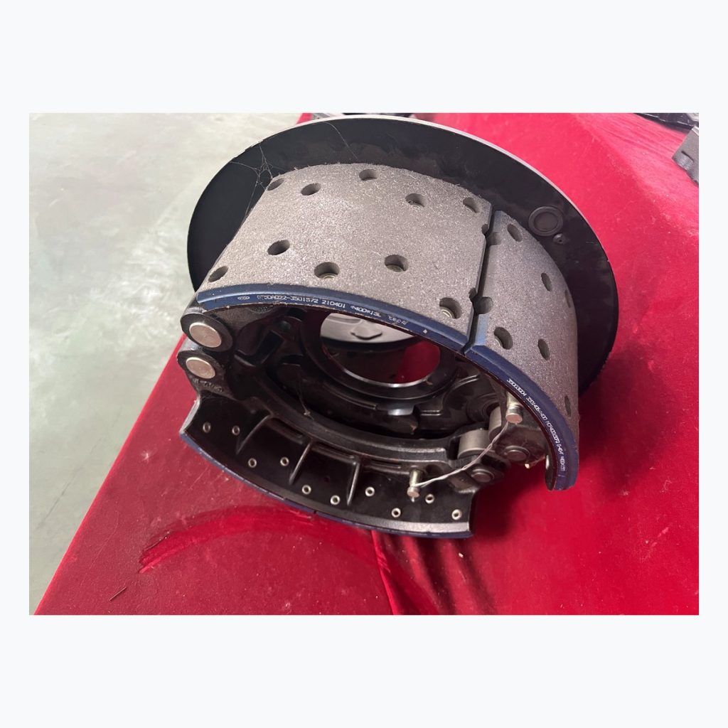 Complete large brake shoe assembly on red table